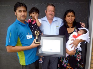 Ashneer and family being presented with his certificate and trophy from Invercargill Regional Manager Glenn Cockroft