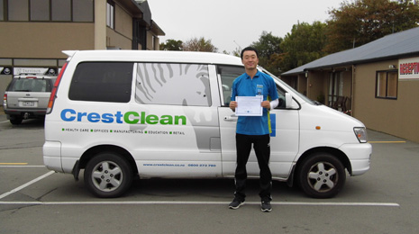 Jason Kang proudly shows off his Certificate recognising 5 years as a CrestClean business owner.