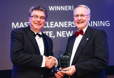 Pictured is Adam Hodge, CEO of Master Cleaners Training Institute receiving the prestigious international trophy for Outstanding Performance in Promotion of the Institute from Colin Hanks, BICSc’s International General Manager.