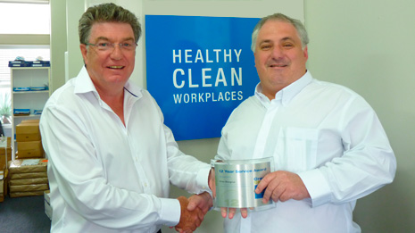 Auckland Central Regional Director Dries Mangnus receiving his 12-Year Service Award from Adam Hodge, CEO of Master Cleaners Training Institute.