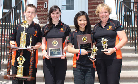 Proud winners Dylan Townsend, Courtney Powell, and Cailey Dayu with Principal of Mission Heights Junior College Joan Middlemiss and their multiple awards.