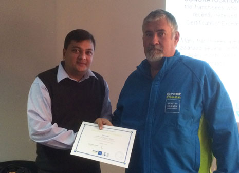 Nivitesh Kumar awarding a Certificate of Excellence to Louis Meyer for his outstanding customer service at Livestock Improvement Corporation.