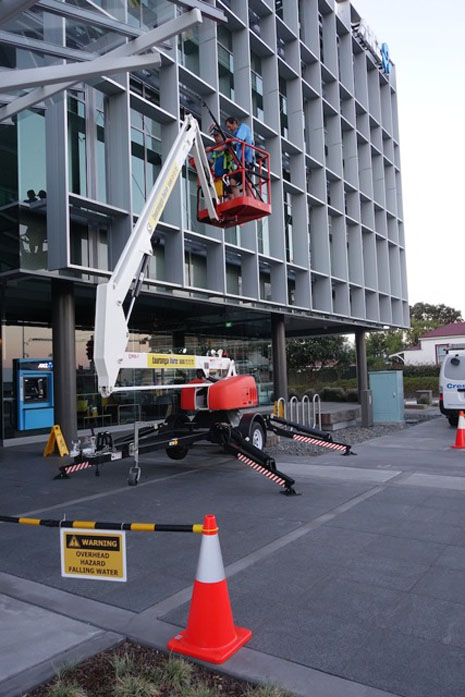 Health and Safety cones, barricades and specific hazard notices are moved along the building as the job progresses.