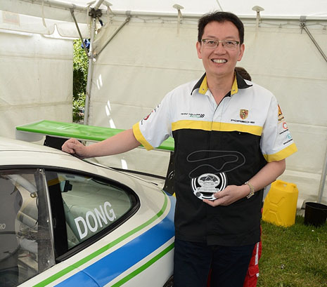 Robert Dong, new owner of the CrestClean-branded Porsche, with his Driver of the Weekend trophy at Manfeild. 