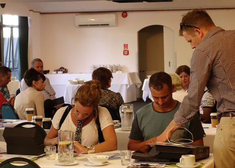 Sam Lewis, Franchise and Procurement Manager, teaching Regional Managers Abby Latu and Jan Lichtwark how to use the CrestClean Van Audit app on their new tablets.