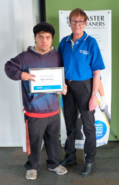 Diego Gonzalez, of MacLaren Park Henderson South Community Trust, received a certificate of completion from the Master Cleaners Training Institute. Diego is pictured with Auckland Operations Coordinator Julie Griffin.