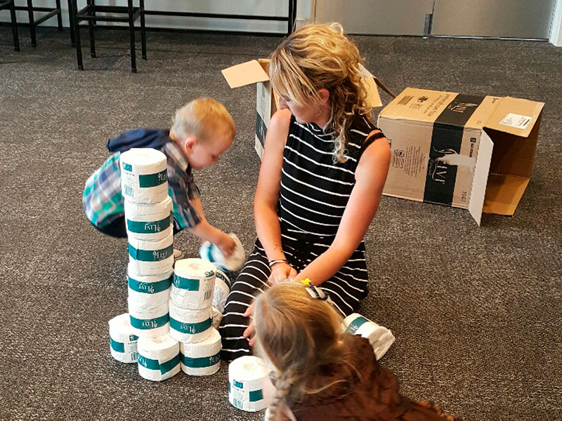 Noah and Kara Borgfeldt decided to make their own tower out of toilet paper with guidance from their mother, Heidi.