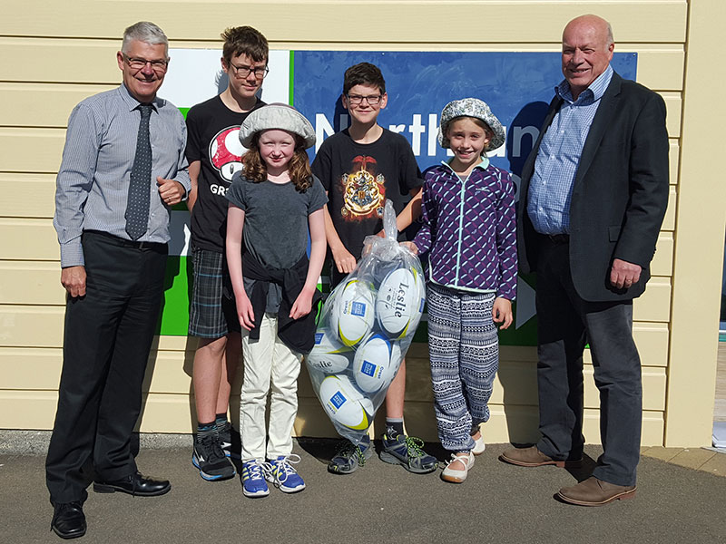 Northland School principal Jeremy Edwards was pleased he won a set of rugby balls. He is pictured with Wellington Regional Manager Richard Brodie.