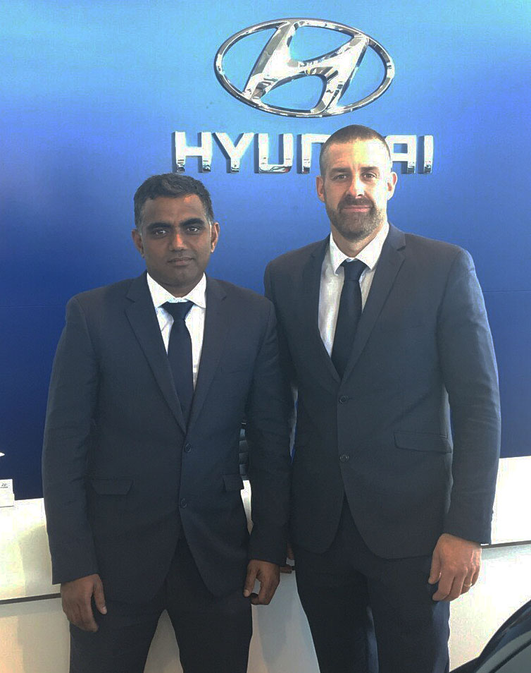 Lakshman Jetti wears two hats. Here he’s seen with Ingham Hyundai’s Dealer Principal Euan Means. Lakshman also cleans the dealership when he’s not selling cars. 