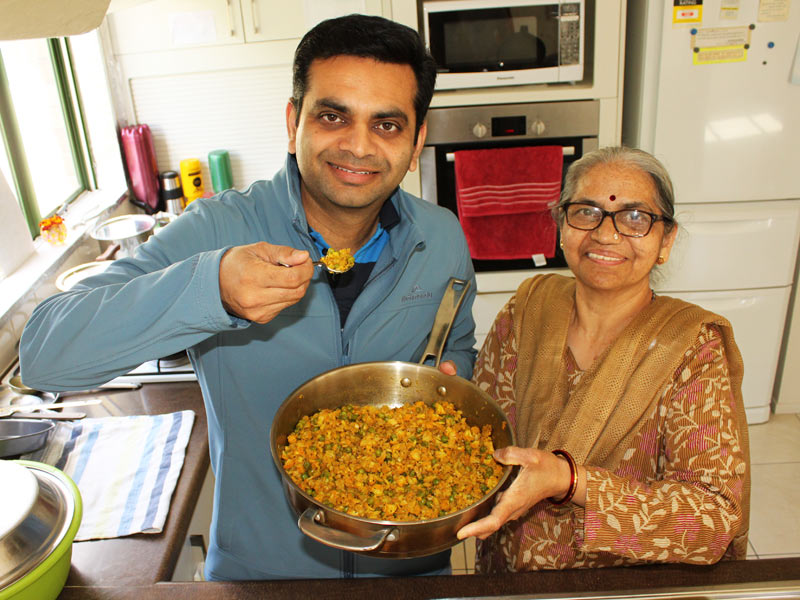 Pinakin Patel helping his mum Niruben in the kitchen.