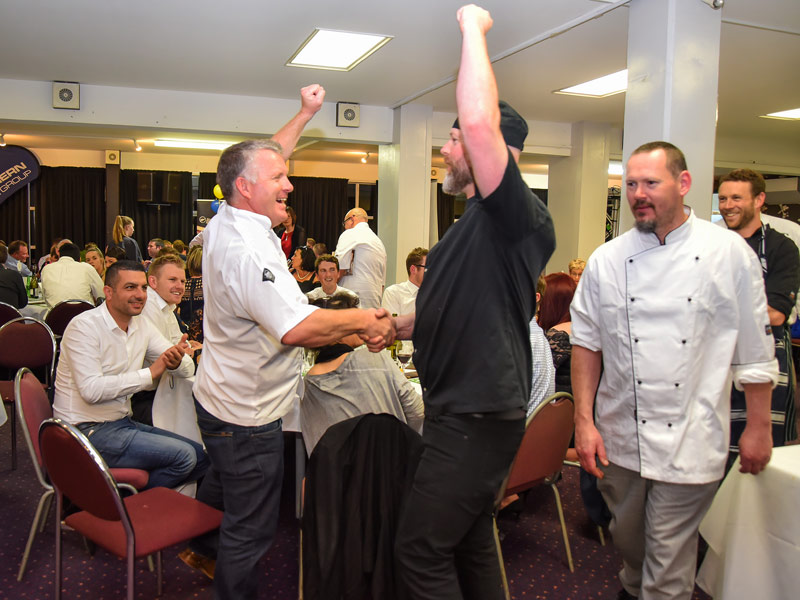 Grant shares a jubilant moment with celebrity chef Andy Aiken at the big night in Dunedin.