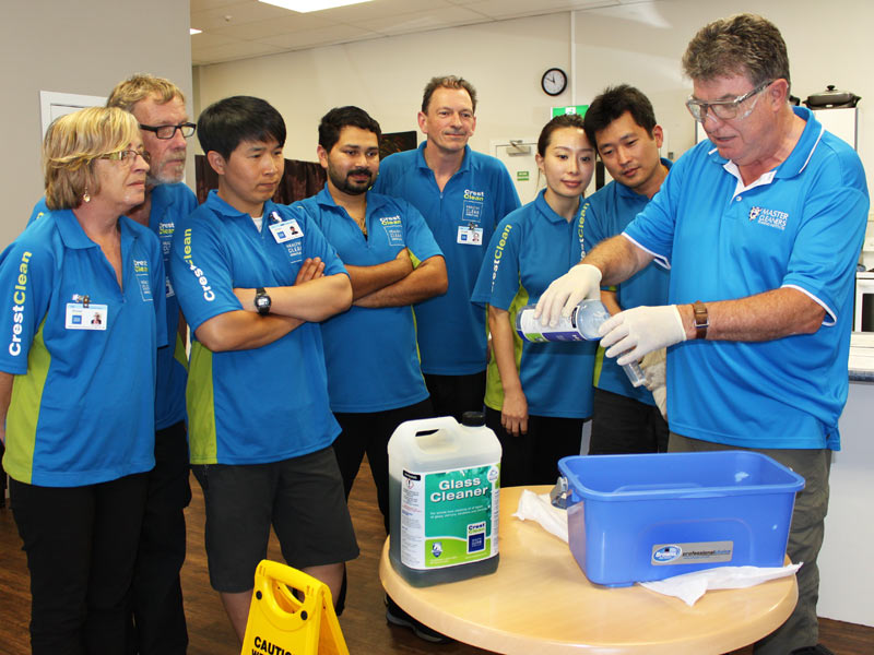 Adam Hodge shows franchisees how to safely pour cleaning solutions to obtain the correct dilution.