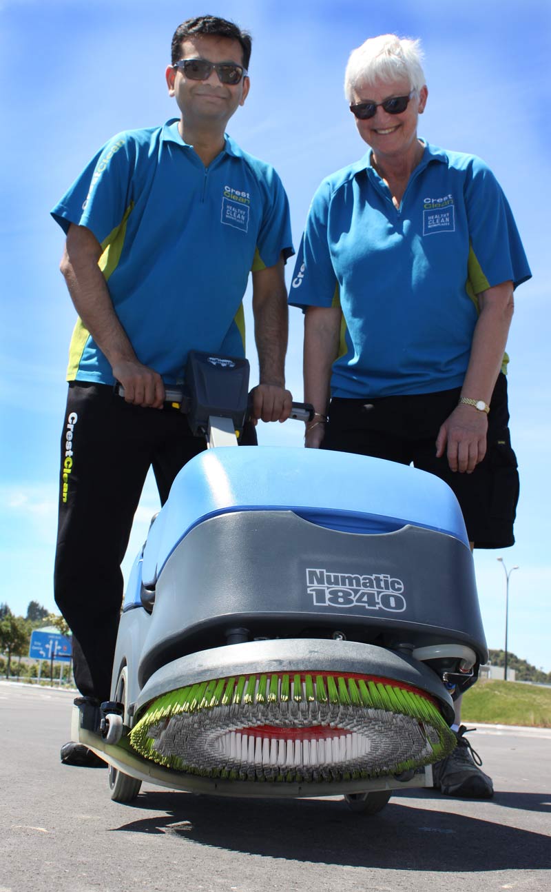 Pinakin Patel and Jill Shepherd check out a battery-powered floor scrubber. 