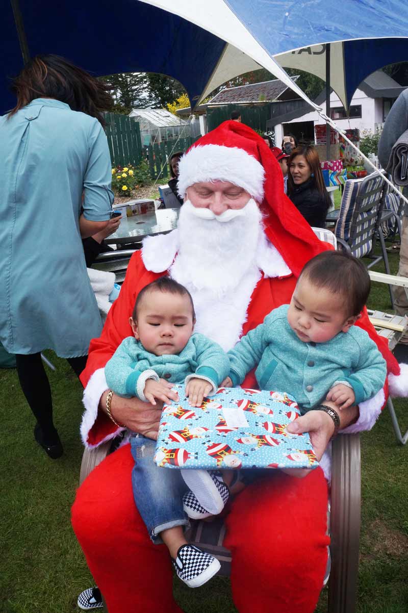 Kylar and Kyros Velez, twin boys who were born in January to Invercargill Crest franchisees Ronette and Karlo Velez, meet Santa.