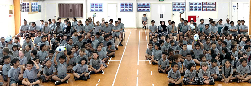 Panmure Bridge School pupils get a touch of the six rugby balls won for their school by Principal Richard Johnston.