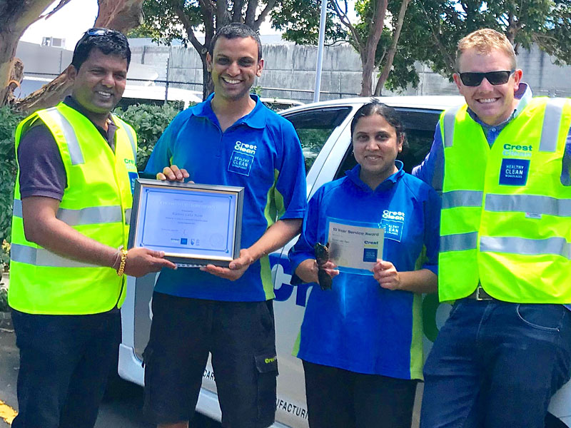 Viky Narayan, CrestClean’s Regional Manager for South and East Auckland, presents the Long Service Award to Shalend and Kamni Ram. Looking on is Sam Lewis, General Manager Franchise Services. 