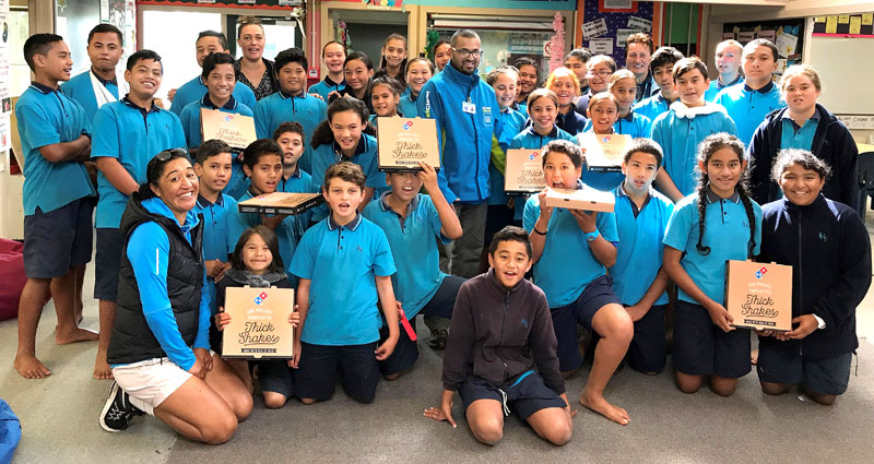 Pupils in Class Amua win the Cleanest Classroom Award at Red Hill Primary School, Auckland. Handing out the pizza prize is CrestClean’s Mohammed Ashad.