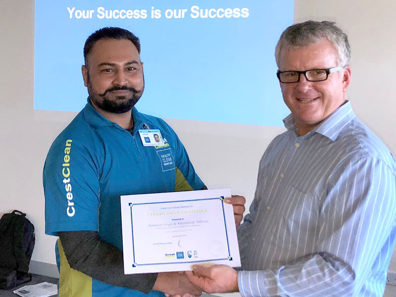 Randeep Singh receives a Certificate of Excellence award from CrestClean Managing Director Grant McLauchlan. 