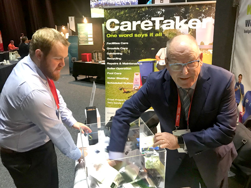 Paul Ferris, CEO of the Catholic Education Convention makes the prize draw on the CrestClean stand. Looking on is Sam Creasy, CrestClean’s National Accounts Manager.