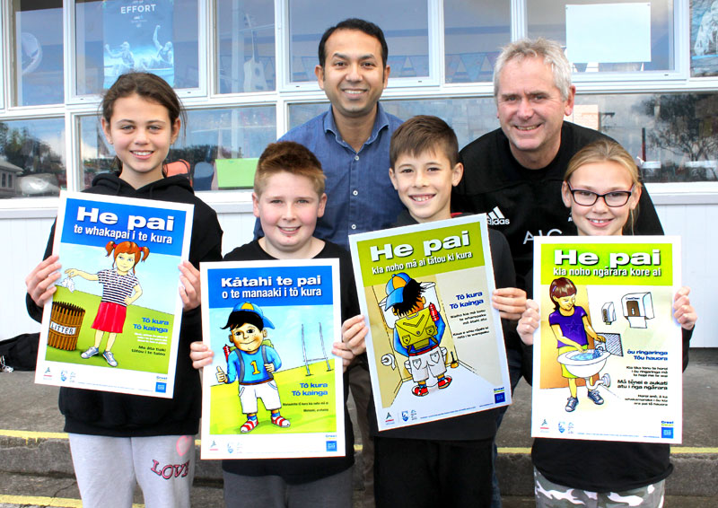 Prasun Acharya (centre), CrestClean’s Taranaki Regional Manager, presents Maori posters to Vogeltown School Deputy Principal Mike George. With them are Room 8 pupils Kirra Jones, Dylan Richards-Beehre, Jacob Ansell and Rylee Schofield. 