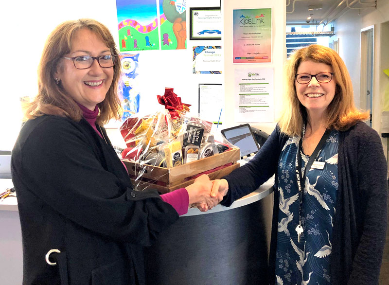 Linda Hill, Crest’s Auckland East Regional Director, with Margaret Walker and the prize hamper. 